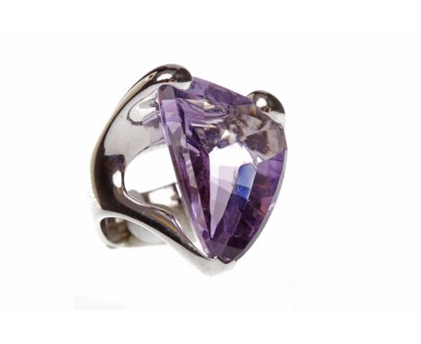 IMPRESSIVE AMETHYST DRESS RINGset with a large triangular amethyst 28x21mm in a heavy eighteen carat white gold setting, size