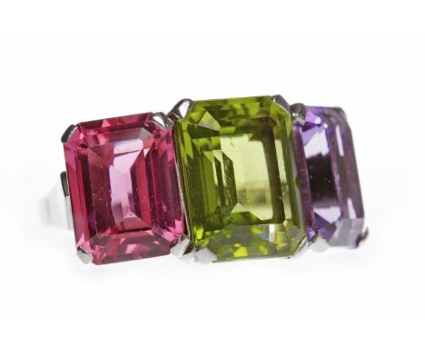 IMPRESSIVE GEM SET RINGset with three emerald cut gems comprising a central peridot 11.9mm long flanked by an amethyst and pi