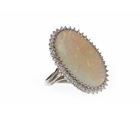 IMPRESSIVE EIGHTEEN CARAT WHITE GOLD OPAL AND DIAMOND DRESS RINGset with a large central oval opal 33x21mm and surrounded by 