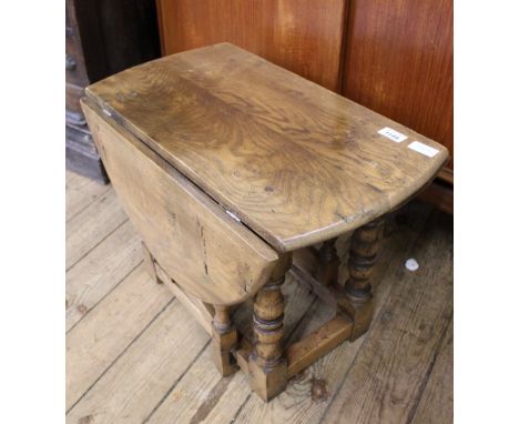 A miniature elm gate leg table