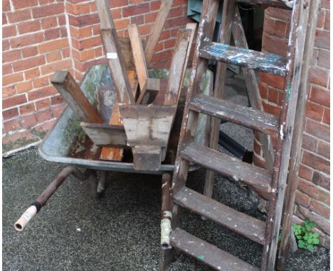 A wheelbarrow, two carpenter trestles and decorative vintage wooden step ladder