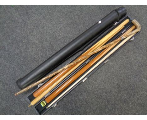 A vintage walking stick together with two snooker cues in cases 