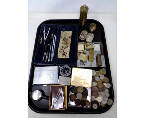 A tray containing a gramophone needle tins, assorted coinage, cased drawing instruments, cigarette case, trench art pot and l