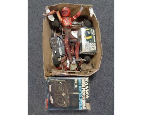 A Sanwa radio control handset (boxed) together with a further box containing a part model cart together with a model engine s