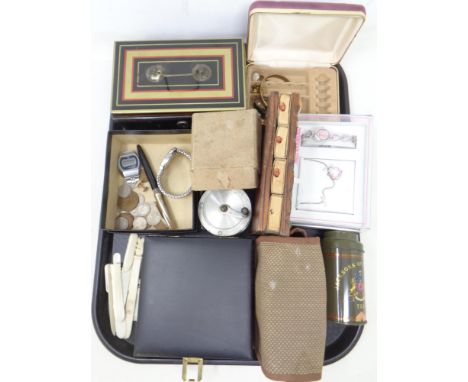 A tray containing wristwatches, coins, dress studs, cased travel game set, cash box, fishing reel etc.