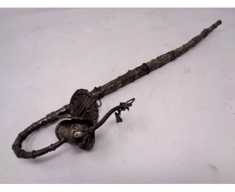 A decorative continental white metal pipe with peacock finial.