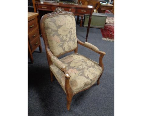 A French walnut tapestry upholstered armchair.