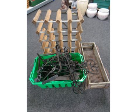 A crate containing wrought iron wall brackets, candle holders etc, together with a metal and wooden plant trough in the form 