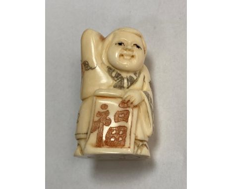 A carved bone Chinese netsuke - Gentleman carrying a scroll 