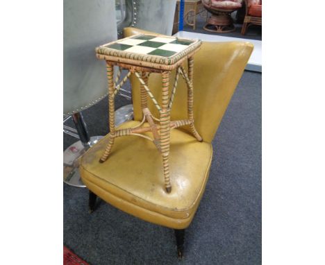 A mid-20th century bedroom chair upholstered in vinyl together with a wicker tile top plant table.