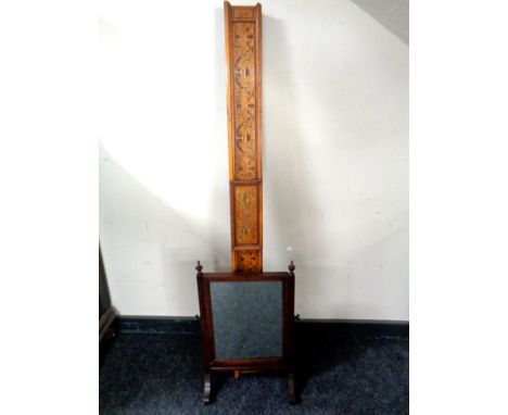 A Victorian dressing table mirror with an inlaid pediment