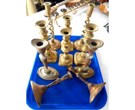 A tray of five pairs of brass candlesticks