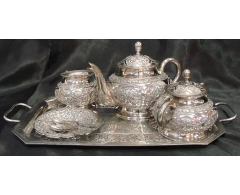 A 19th century Anglo-Indian tea set and tray, decorated with floral motifs, comprising tea pot, lidded sucrier, creamer, dish