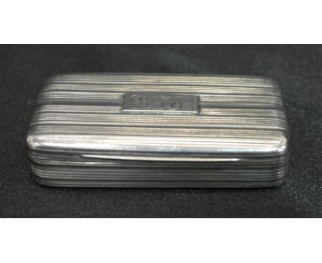 A George III silver snuff box with reeded design and applied monogrammed plaque to the top, gilt interior: London 1799, maker
