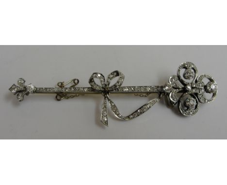 A Victorian diamond set 18ct arrow brooch set with Fleur de Lys tip, articulated Diamond set bow to the shaft approx 2.4 tota