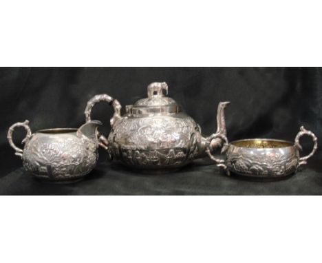 A 19th century Dass and Dutt Calcutta three-piece tea set embossed with farming scenes and floreate scrollwork tea pot with e