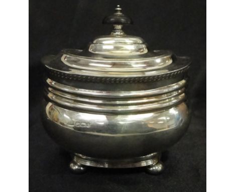 A 19th century silver tea caddy, Sheffield maker's mark GH, hinged lid with ebony finial on ball feet 
