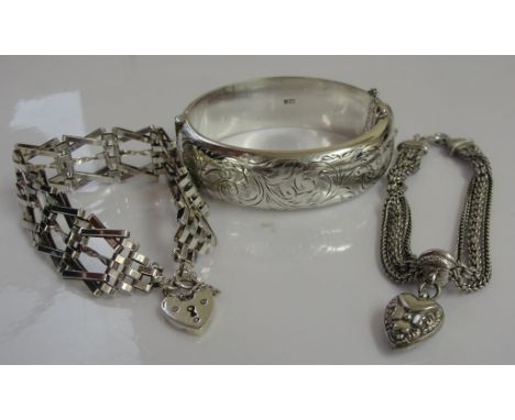 A silver bangle; together with a 5-bar gate bracelet and a Victorian chain bracelet