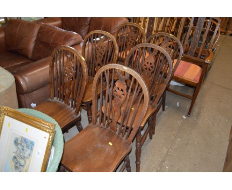 A set of six elm seated and stick and wheel back kitchen chairs 