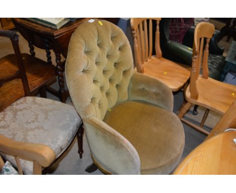 A green upholstered button back arm chair 