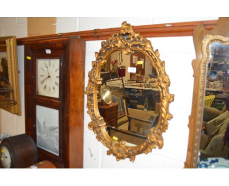 A gilt framed oval wall mirror