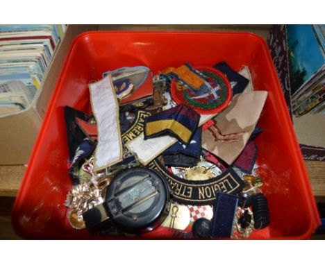 A tub of mixed badges, pocket compass etc. 