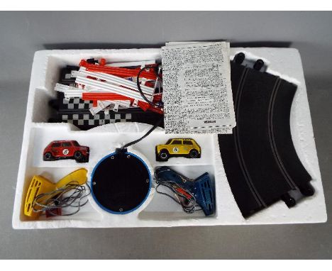 Scalextric - A boxed vintage Scalextric 300 Set. The set contains two minis, track, barriers, power supply, and two controlle