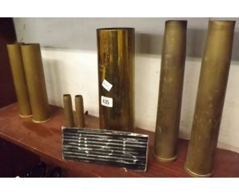 SHELF OF VARIOUS MILITARY BRASS SHELLS    