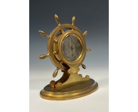 A 19th century gilt brass novelty desk or shelf barometer, of nautical interest as a ship's wheel, oval base, 20cm high, reta