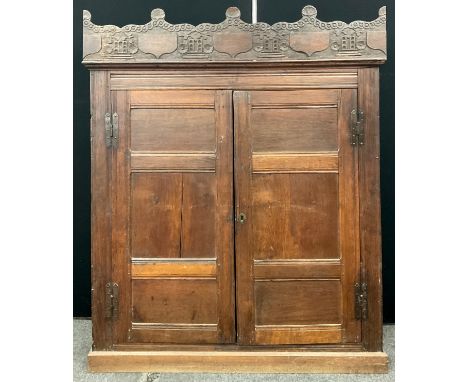 A 19th century oak cupboard, carved railing above moulded cornice to frieze, two panel doors, 172cm height, 137cm width, 33cm