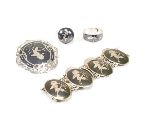 A Siam silver and black enamel jewellery suite. The lot to include an oval brooch. The brooch having a ring on verso to attac