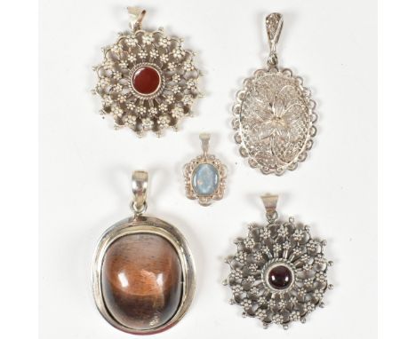 A collection of silver and gem set necklace pendants. The necklace pendants to include metal filigree, flowers, metal beadwor