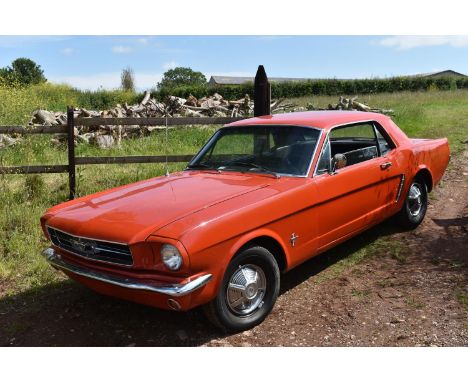 A 1965 Ford Mustang coupé, unregistered, orange.Fords  Mustang, the original Pony car based on the Falcon compact has become 