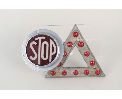 A stop light bezel and lens plus a vintage warning triangle