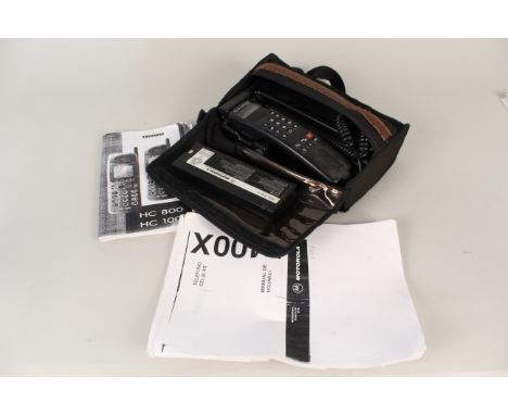 A vintage cased Motorola mobile phone circa mid 90's with charger, battery and instructions