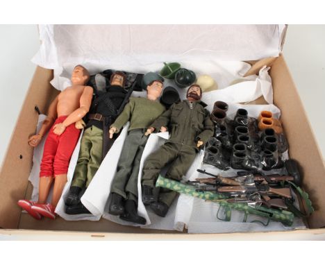 A collection of Action Man figurines with assorted clothes and accessories