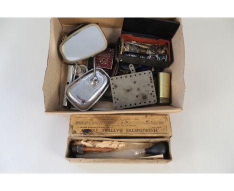 A box of various vintage car parts and tools