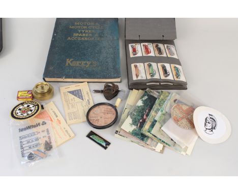 A collection of motoring ephemera including vintage tax discs, postcards, badges etc