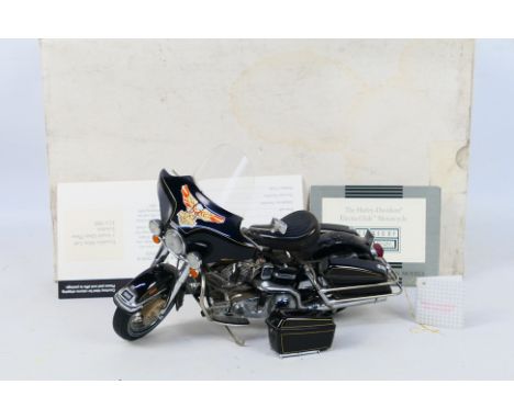 Franklin Mint - A boxed 1:10 scale Franklin Mint 'The Harley Davidson Electra Glide Motorcycle'. The model has a detached (pr