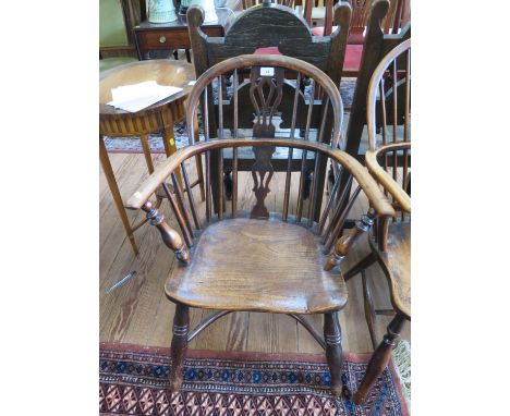 A yew and elm Windsor chair, the spindle back with pierced splat over a moulded seat on ring turned legs joined by a crinolin