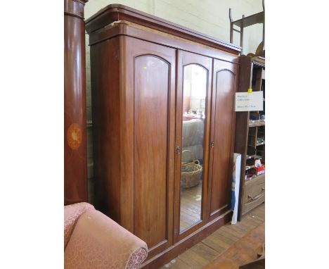 An Edwardian inlaid mahogany two door wardrobe, the doors with oval bevelled mirrors, above two drawers and bracket feet, 159