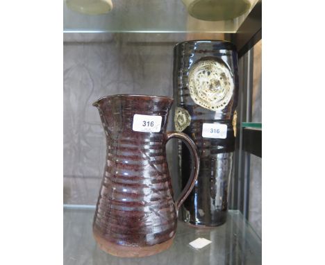 A Bernard Leach Pottery brown glaze stoneware jug, 20 cm high, and a similar brown glaze vase with indistinct mark, 30 cm hig