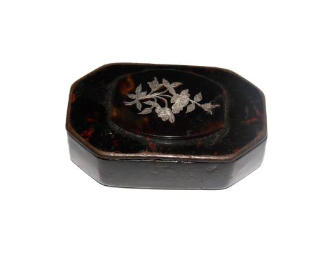 A papier mache snuff box with silver inlaid floral decoration 