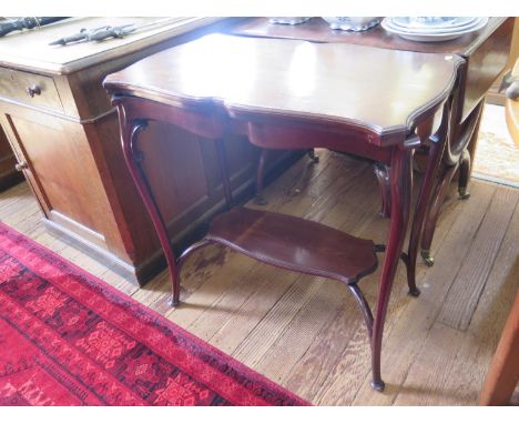 An Edwardian mahogany fold over card table, the shaped top over cabriole legs joined by an undershelf, 77 cm wide 