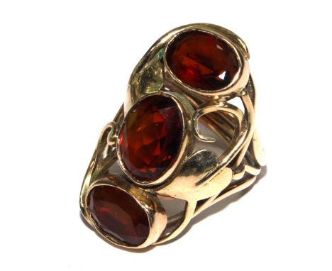 A 9 carat gold ring with three garnets 