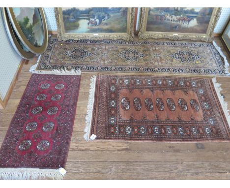 A Bokhara rug, with a single row of seven guls, on a red field, 127 x 80 cm, another small Bokhara rug, and a runner (3) 