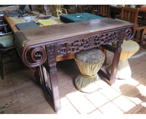 A Chinese hardwood altar or side table, possibly Huang Huali, the top with curved ends above a square scroll carved frieze on