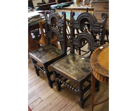 A pair of Yorkshire or Derbyshire backstool chairs, carved arched back rails with pendants over solid seats on bobbin turned 
