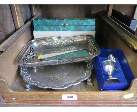 A silver plated tray on four feet, an egg cup and spoon and a fruit set 
