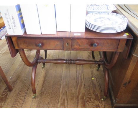 A 19th century continental style sofa table, with two frieze drawers on X-frame supports, joined by a pole stretcher, on bras